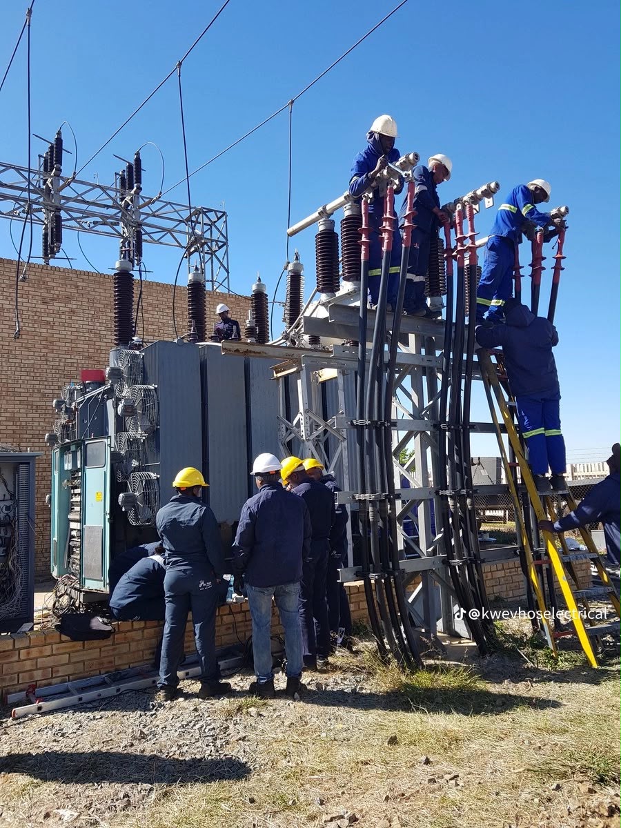 Crew terminating medium-voltage cables into a transformer on site