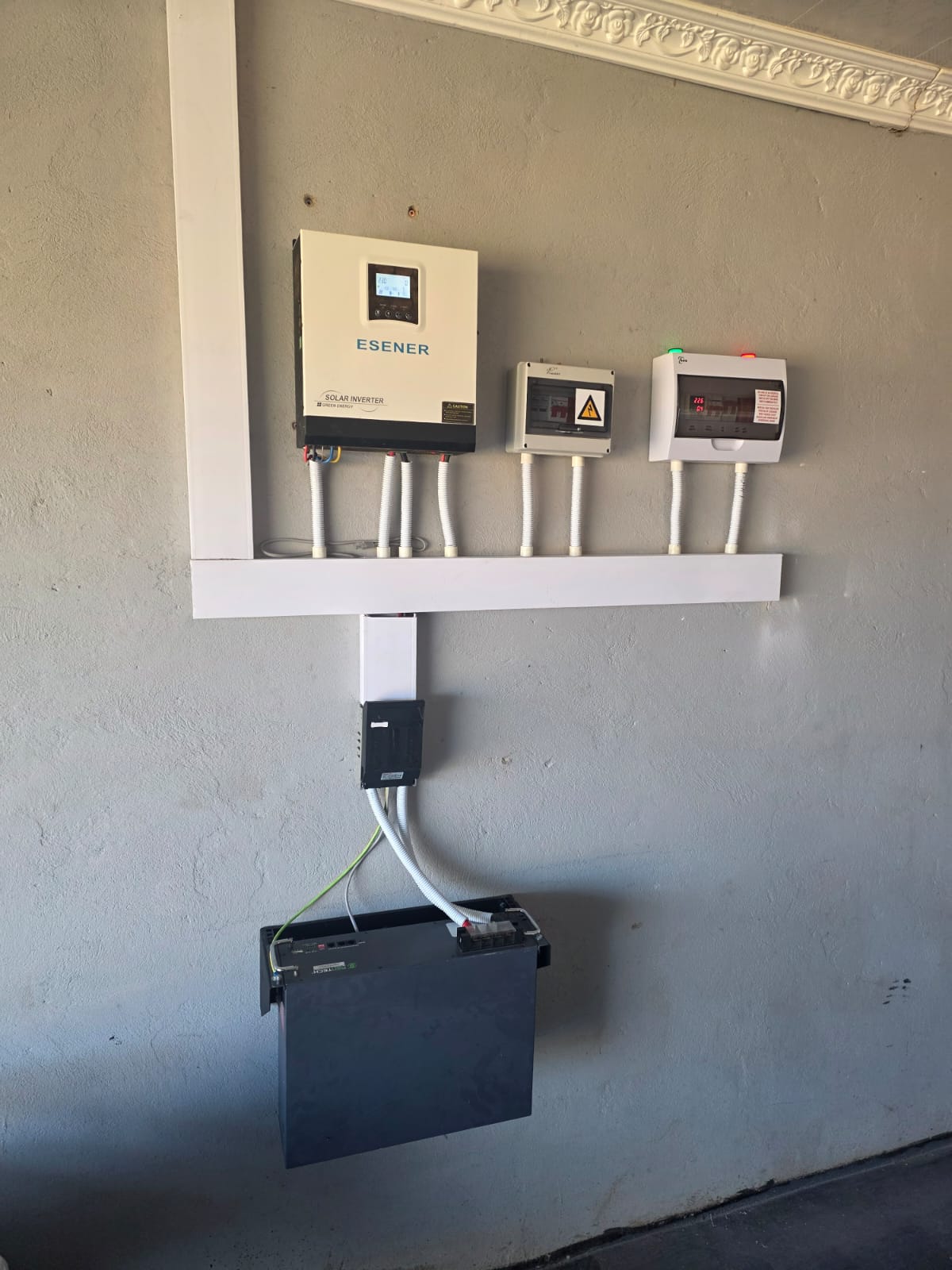 Solar inverter, isolators and battery mounted on a wall